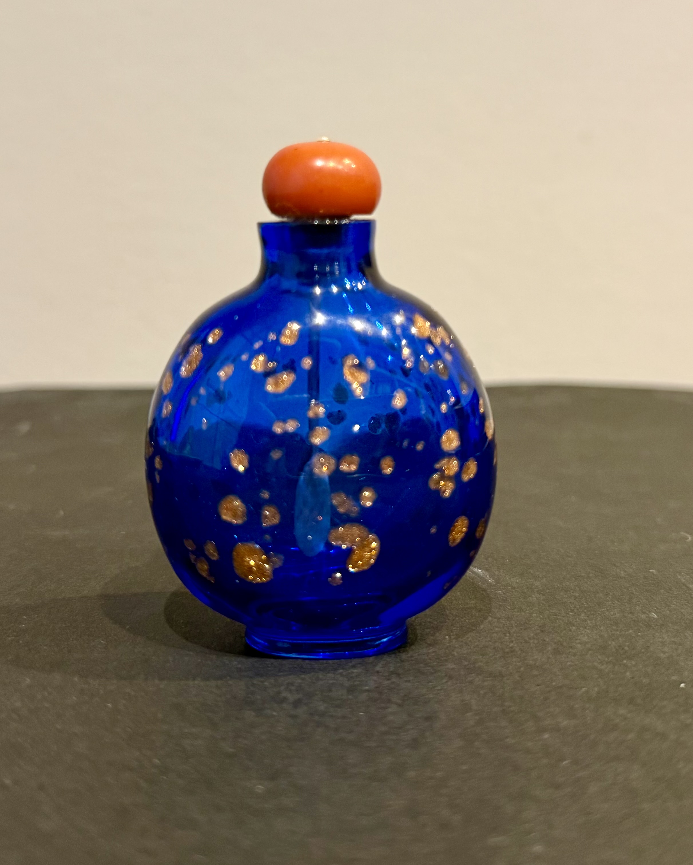 Snuff bottle with a rounded shape in translucent sapphire blue glass
with splash of golden aventurine  - China period Qianlong 1736.1795